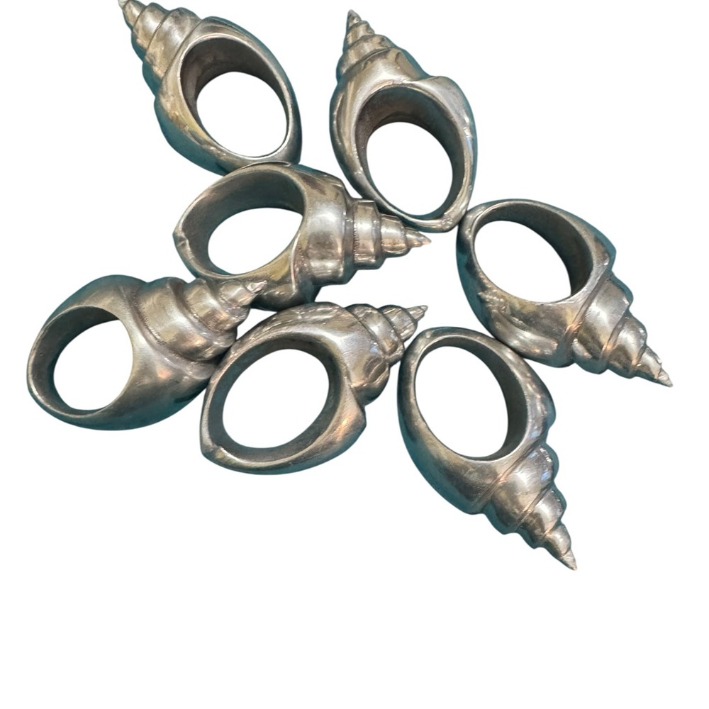 Set of 7 silver toned aluminum conch shell napkin rings